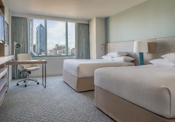 A view of a hotel room with two queen beds